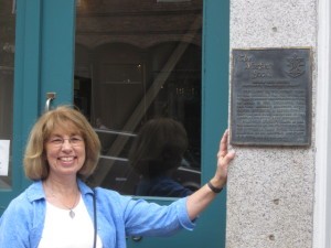 Susann Bishop, beside The Mosher Press plaque.